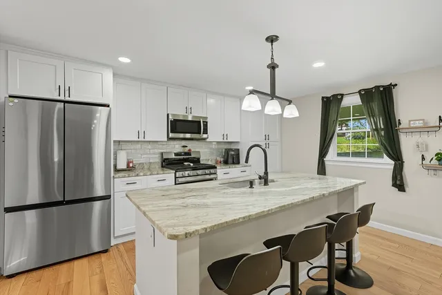 a kitchen with refrigerator a sink and a refrigerator