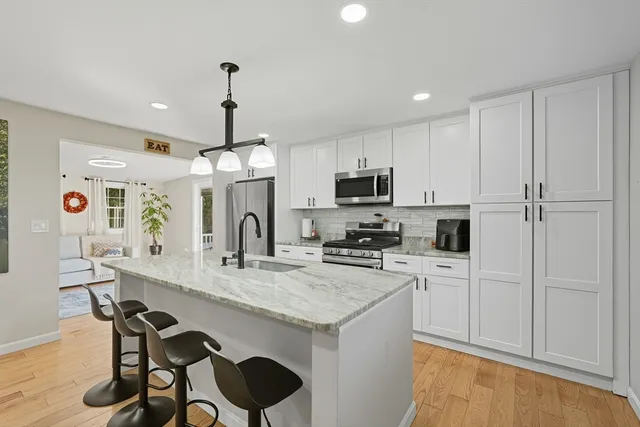 a kitchen with sink cabinets and refrigerator