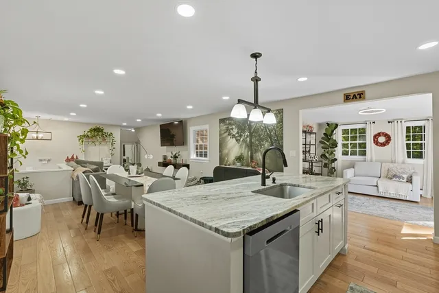 a kitchen with center island table and chairs