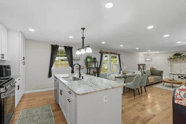 a kitchen with stainless steel appliances granite countertop a sink and a refrigerator
