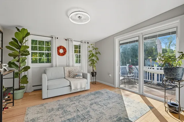 a living room with furniture a rug and a window