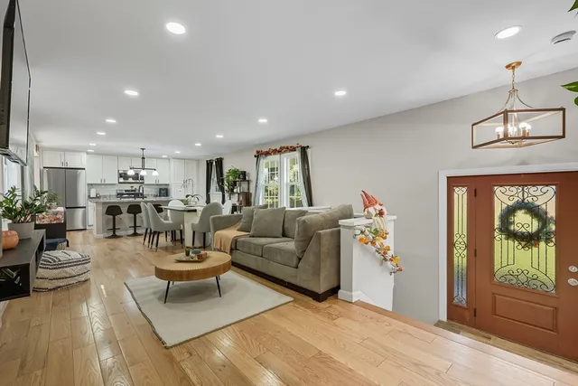 a living room with furniture a window and a flat screen tv