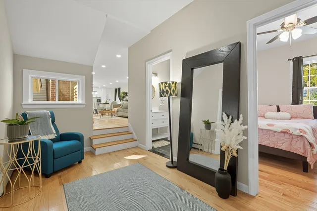 a bedroom with furniture and a wooden floor