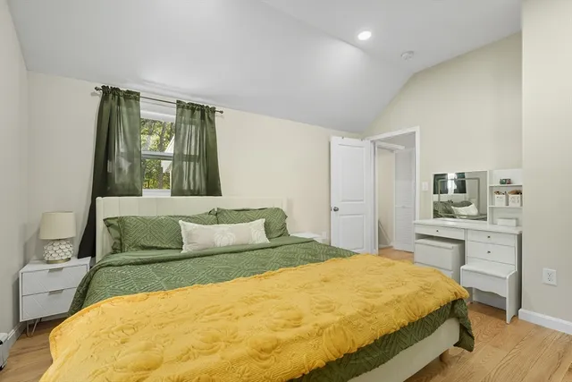 a bedroom with a large bed and a dresser