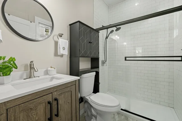 a bathroom with a sink toilet and shower