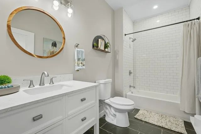 a bathroom with a toilet a sink and a mirror