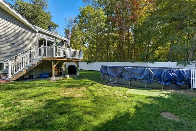 a view of a house with a yard and sitting area