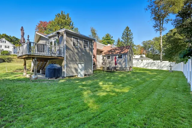 a view of an house with backyard space and balcony