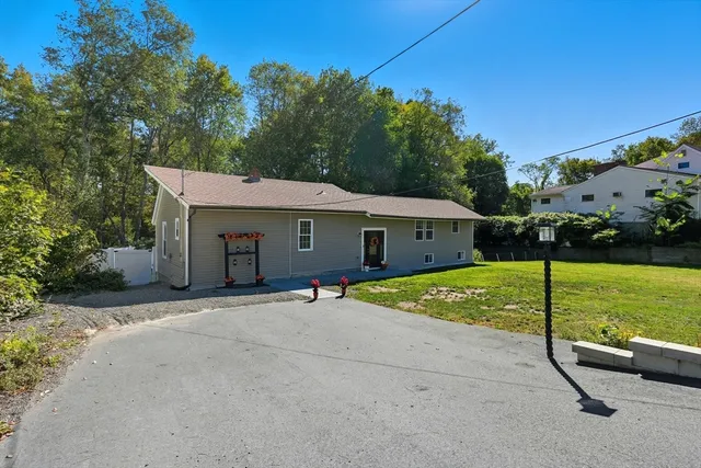 a view of a house with backyard and a garage