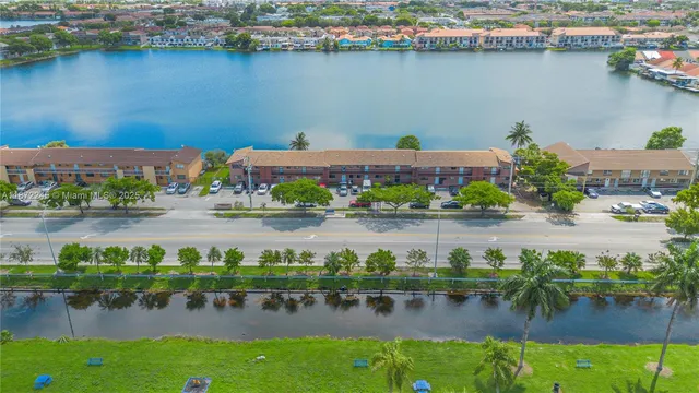 an aerial view of ocean and residential houses with outdoor space and lake view