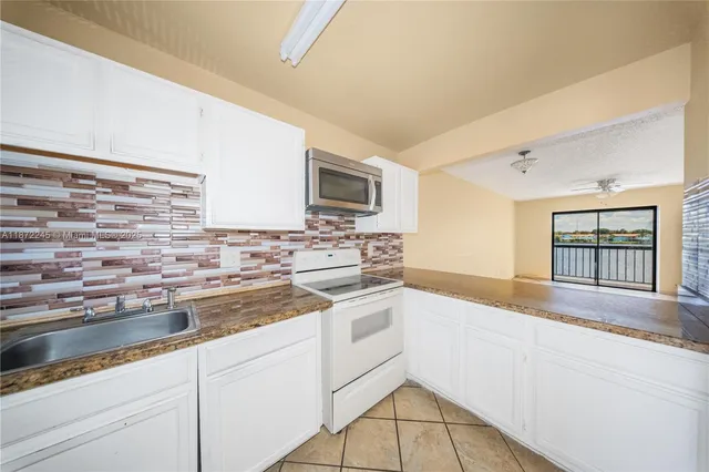 a kitchen that has a sink and a stove