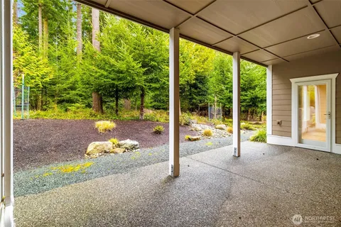 a view of a porch with two chairs and a yard