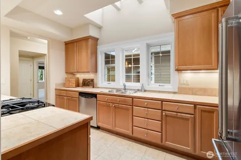 a kitchen with a sink stove and cabinets