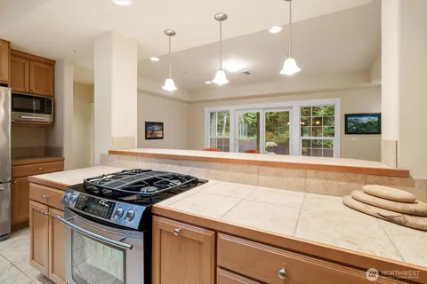 a kitchen with granite countertop a stove and a sink