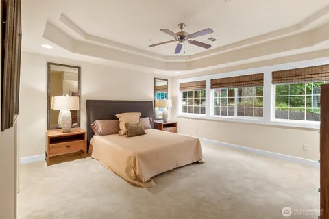 a bedroom with a large bed and a large window