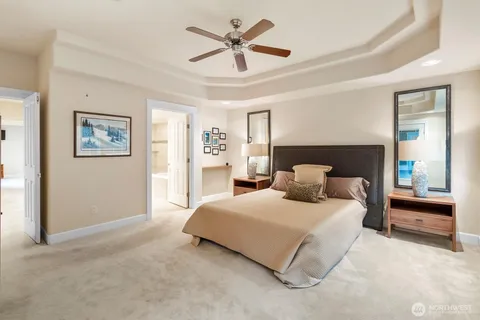 a bedroom with a bed and a ceiling fan