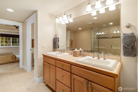 a bathroom with a sink double vanity and a mirror