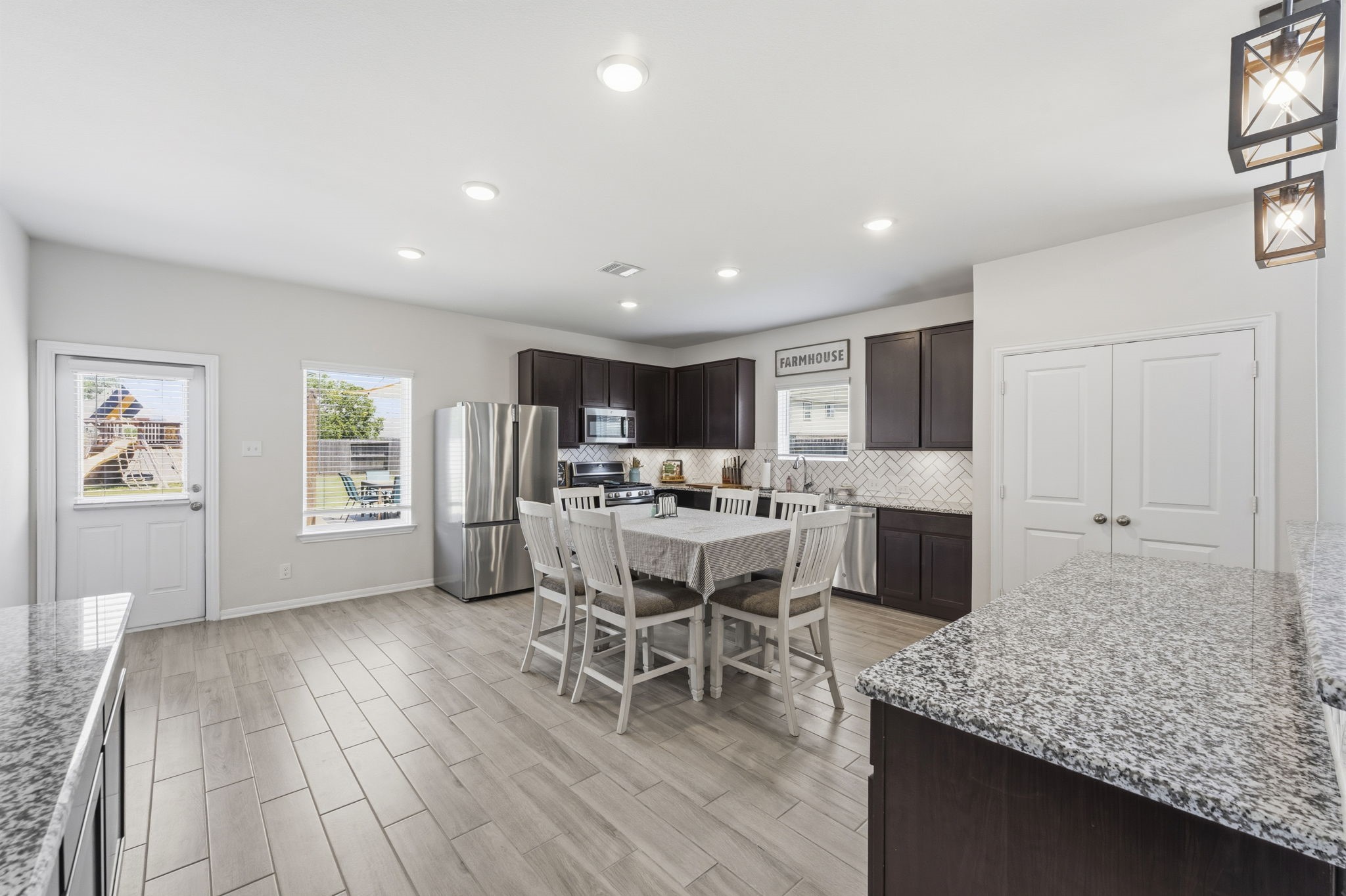 2401 Abbot Brk Drive Rosharon, TX 77583 - Photo 16 of 50 The adjoining breakfast area offers panoramic backyard views, surrounded by windows that fill the space with natural light. With easy access to the patio and backyard, this area is perfect for seamless indoor-outdoor entertaining.