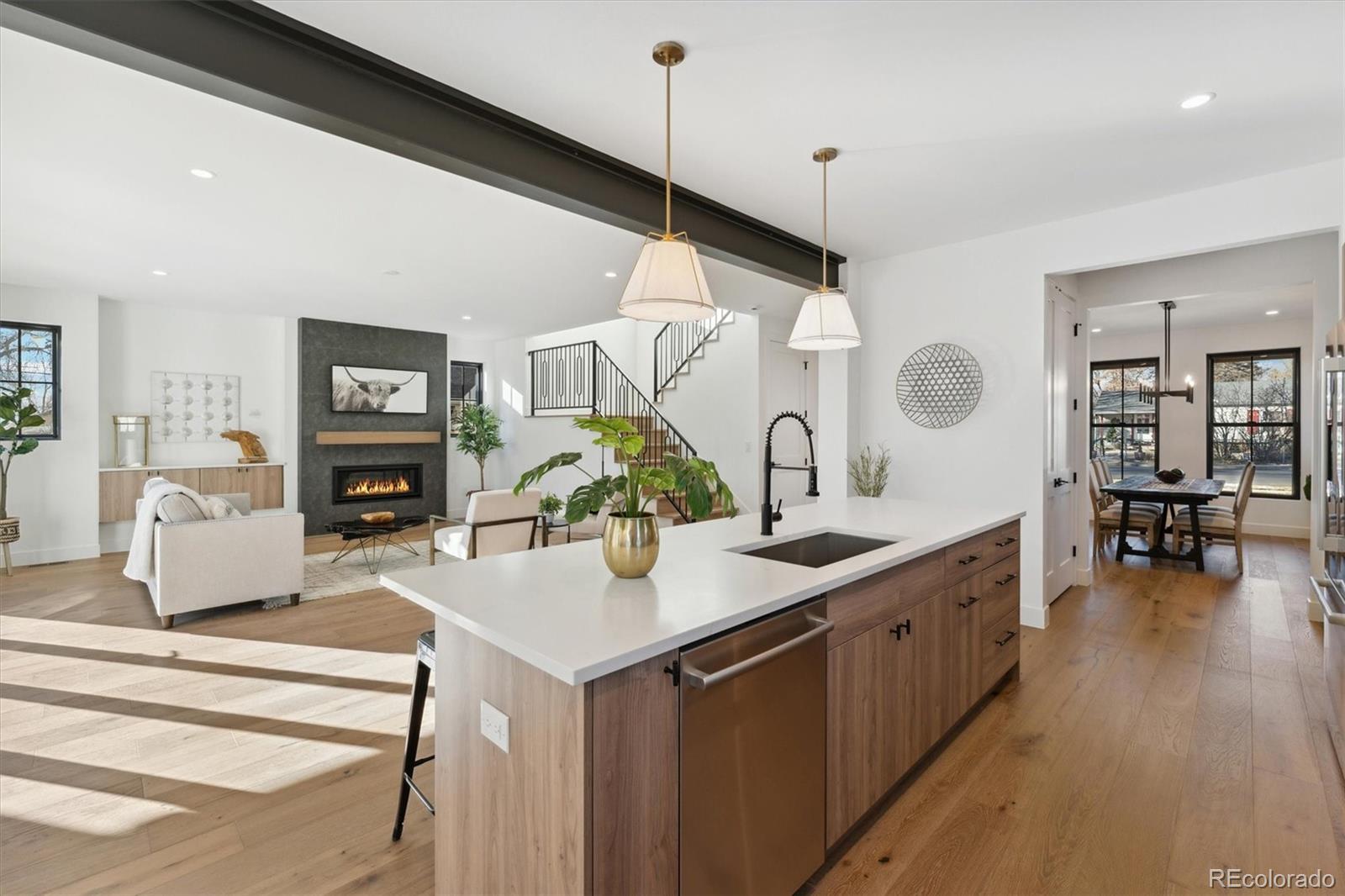2540 Jay Street Edgewater, CO 80214 - Photo 12 of 37 a room with kitchen island a wooden floor and a chandelier