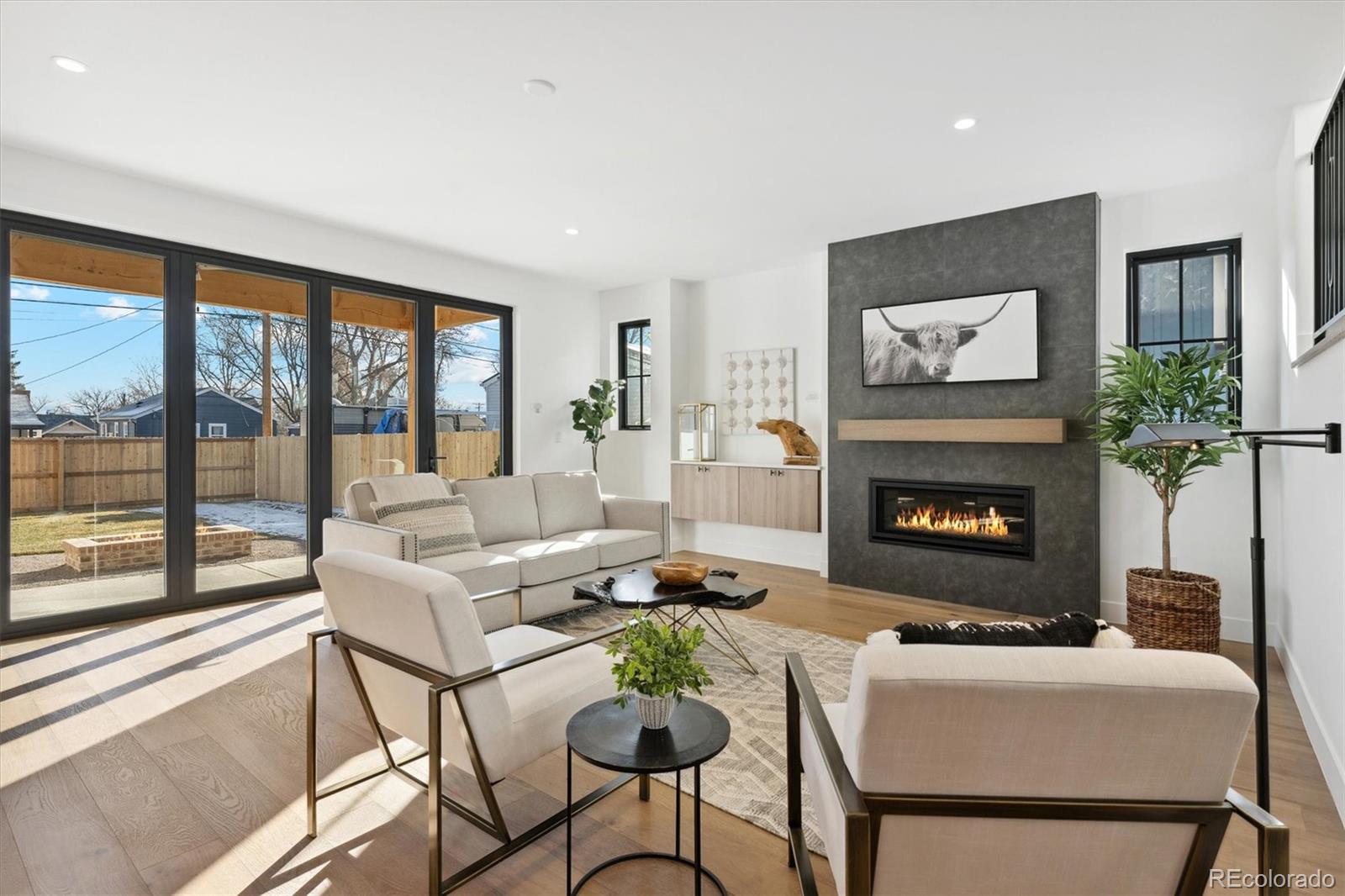 2540 Jay Street Edgewater, CO 80214 - Photo 16 of 37 a living room with furniture a floor to ceiling window and a fireplace