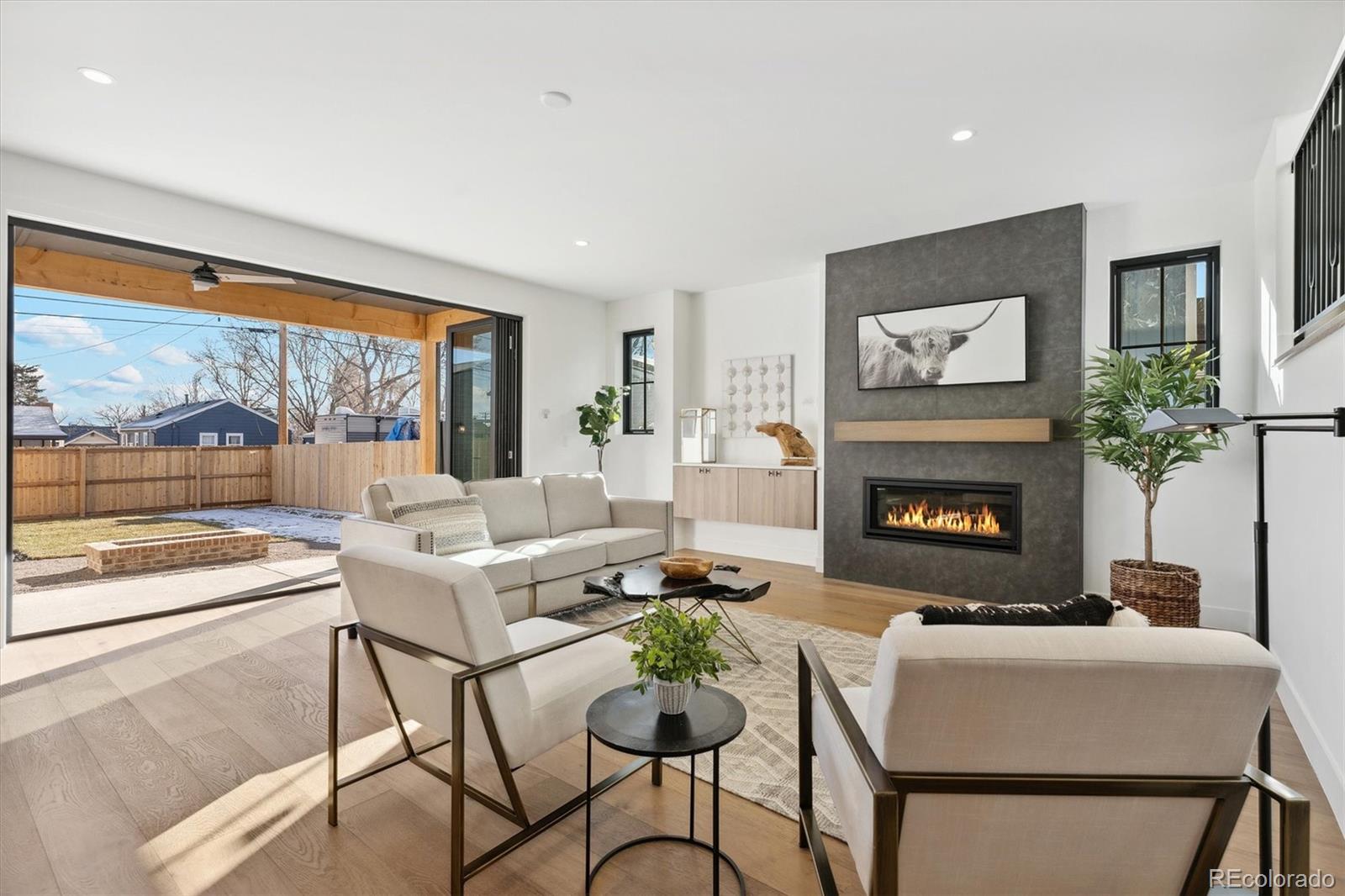 2540 Jay Street Edgewater, CO 80214 - Photo 17 of 37 a living room with furniture a flat screen tv and a fireplace