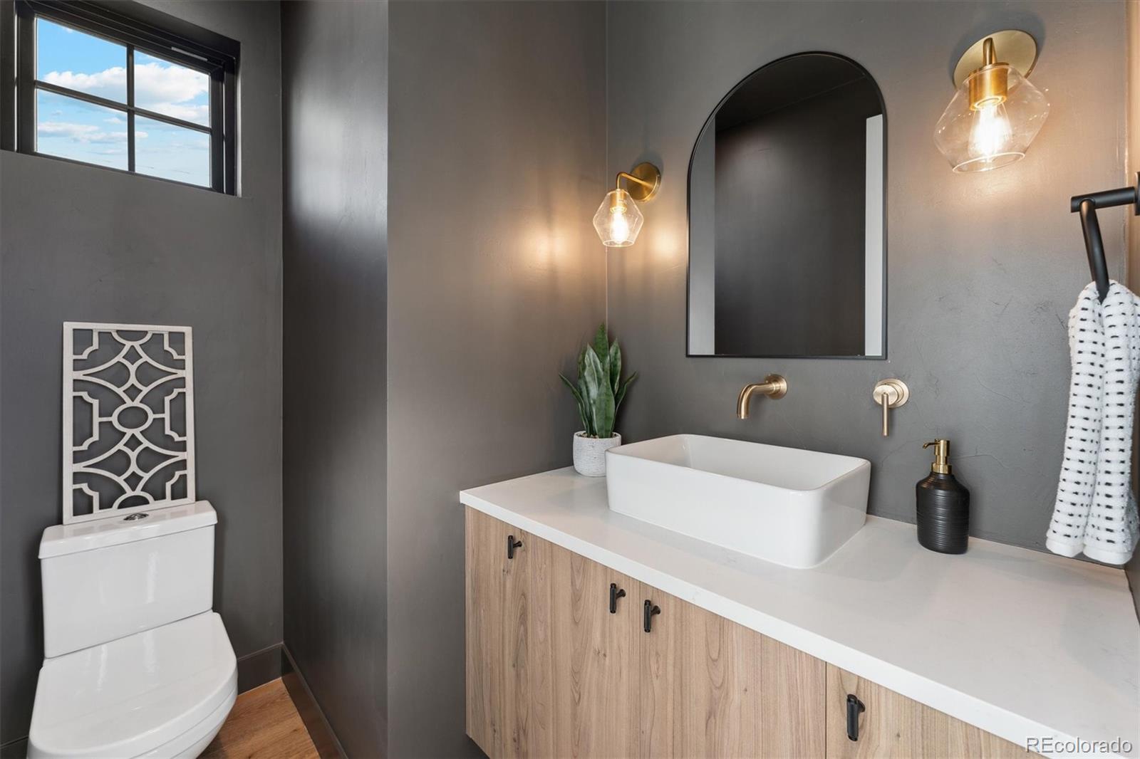 2540 Jay Street Edgewater, CO 80214 - Photo 18 of 37 a bathroom with a sink a toilet and mirror