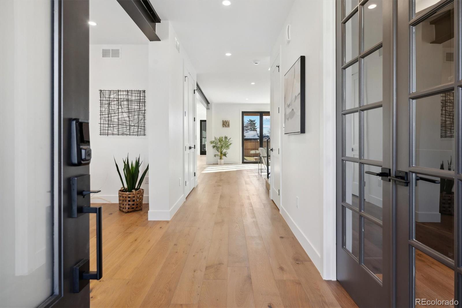 2540 Jay Street Edgewater, CO 80214 - Photo 2 of 37 a view of a hallway with wooden floor and glass door