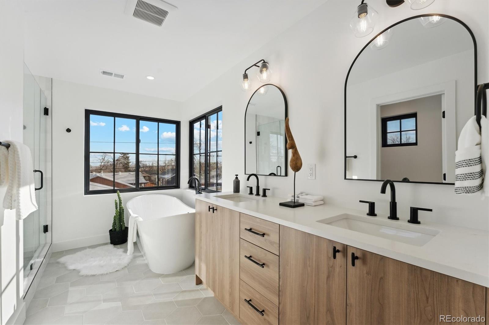 2540 Jay Street Edgewater, CO 80214 - Photo 24 of 37 a spacious bathroom with a double vanity sink a mirror and a bathtub