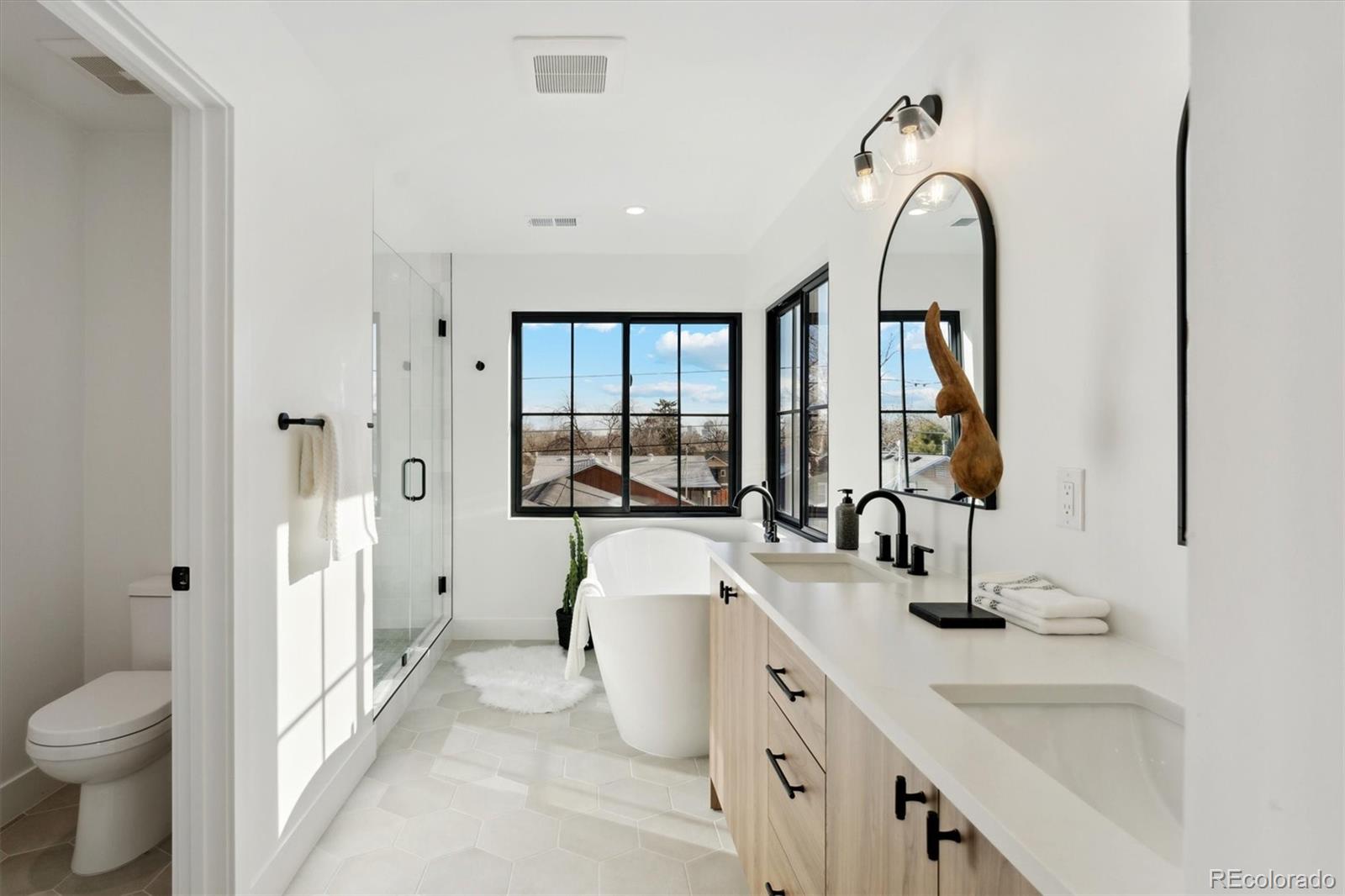 2540 Jay Street Edgewater, CO 80214 - Photo 25 of 37 a bathroom with a double vanity sink toilet mirror and bathtub