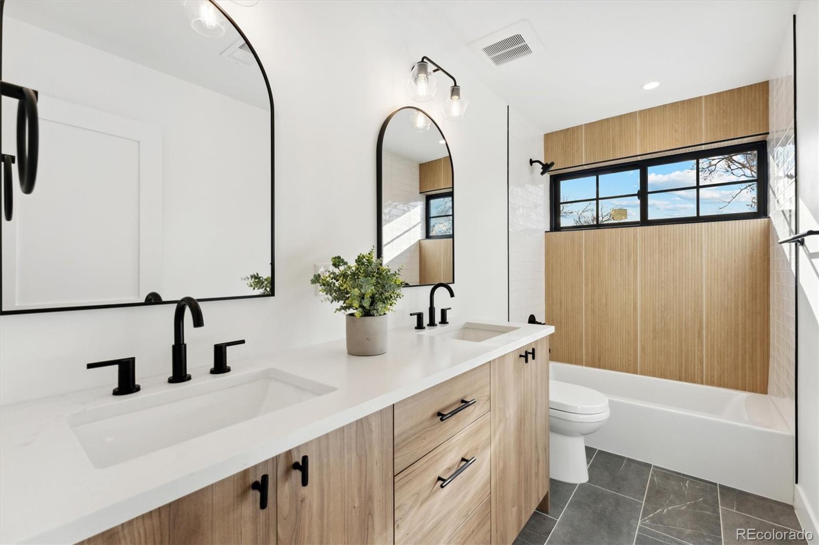 2540 Jay Street Edgewater, CO 80214 - Photo 28 of 37 a bathroom with a double vanity sink and a mirror