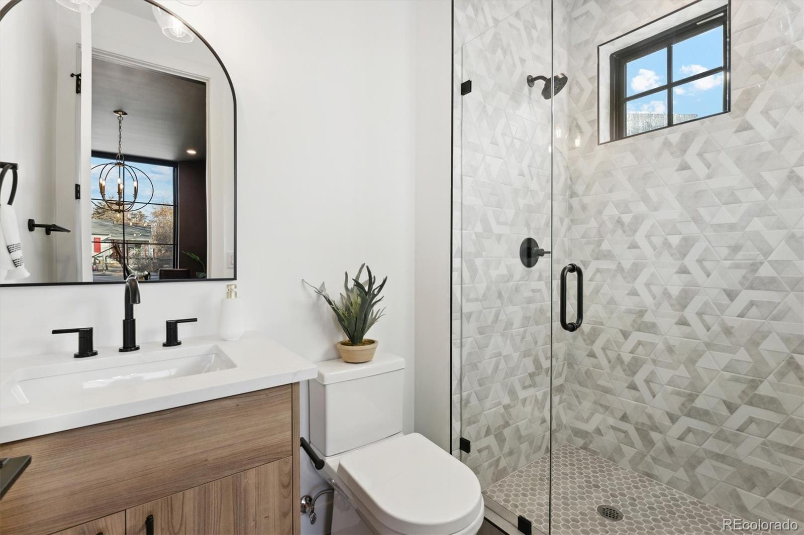 2540 Jay Street Edgewater, CO 80214 - Photo 5 of 37 a bathroom with a toilet sink vanity granite and shower