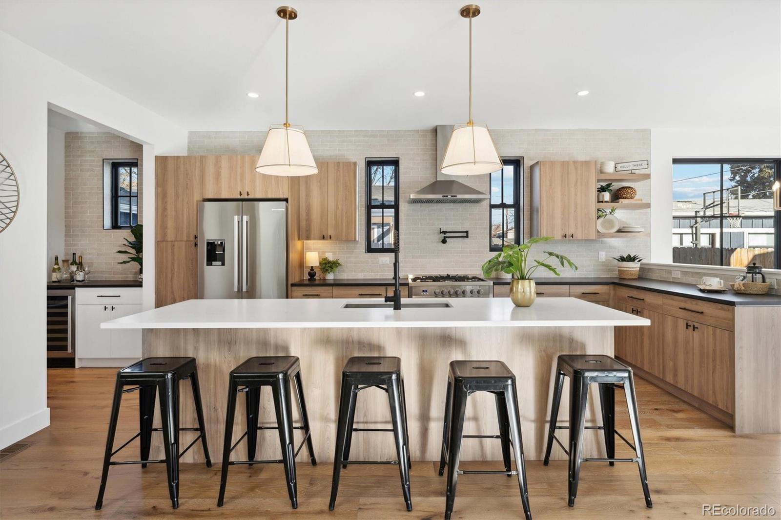 2540 Jay Street Edgewater, CO 80214 - Photo 9 of 37 a kitchen with cabinets and chairs