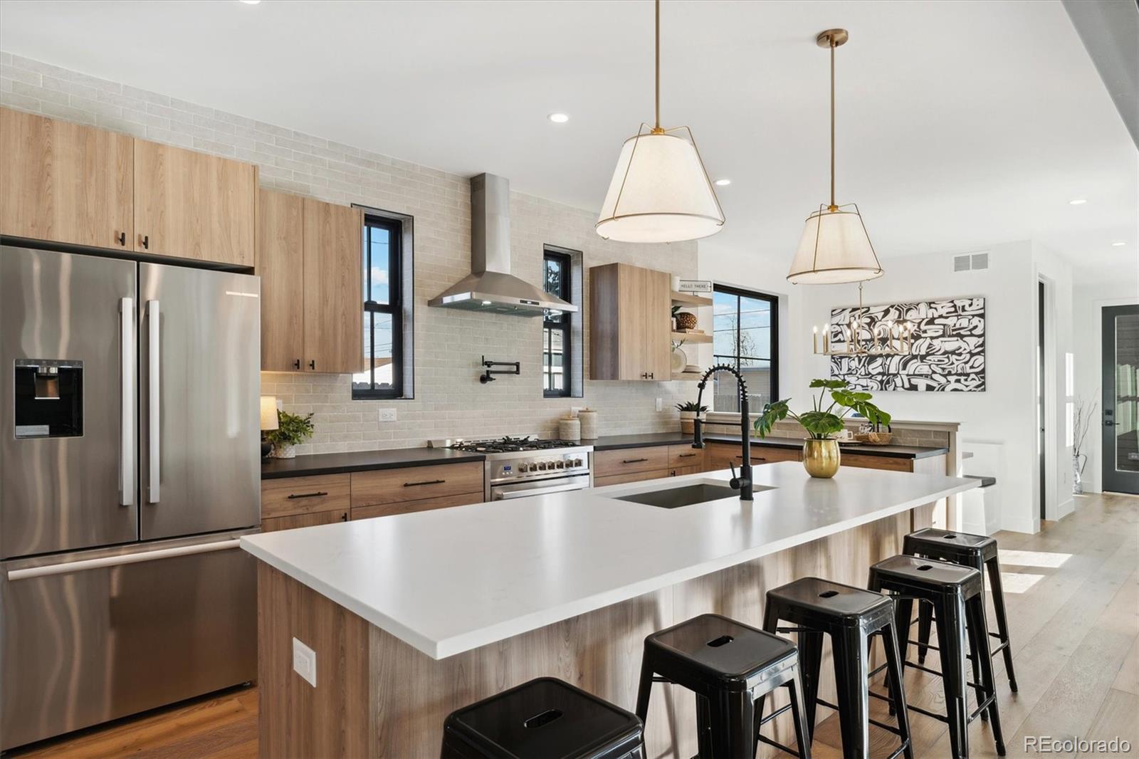 2540 Jay Street Edgewater, CO 80214 - Photo 10 of 37 a kitchen with granite countertop a sink a center island and stainless steel appliances