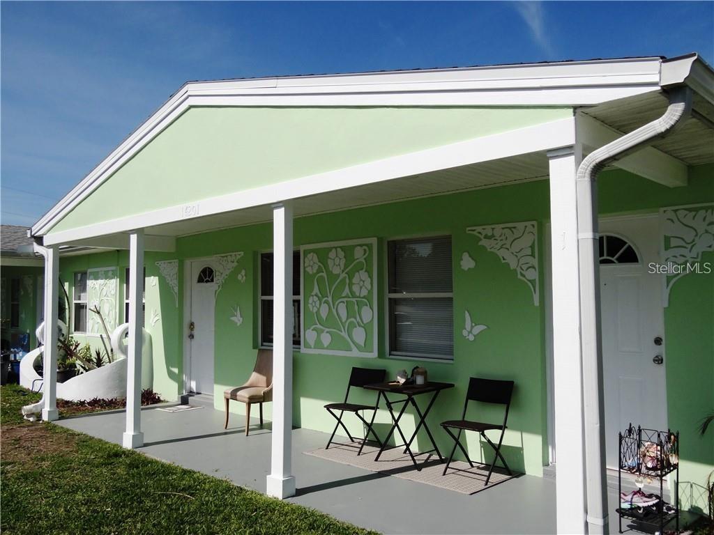 14201 Marguerite Drive Madeira Beach, FL 33708 - Photo 1 of 1 a backyard of a house with table and chairs