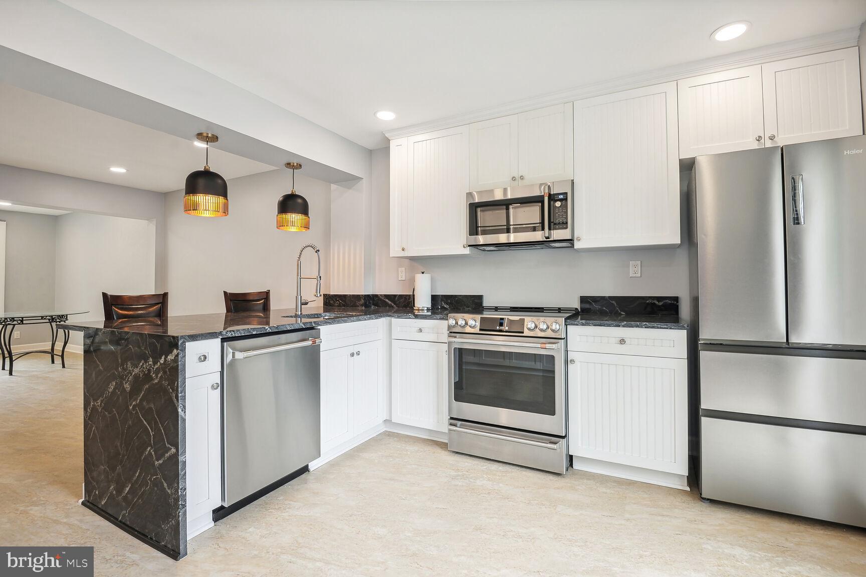 1635 Valencia Way Reston, VA 20190 - Photo 12 of 22 a kitchen with a refrigerator and a stove top oven