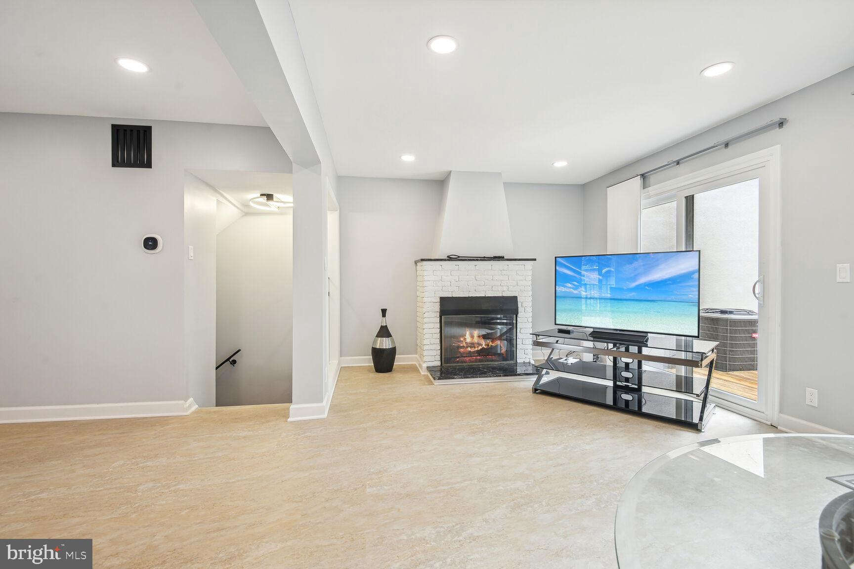 1635 Valencia Way Reston, VA 20190 - Photo 10 of 22 an empty room with furniture and a fireplace