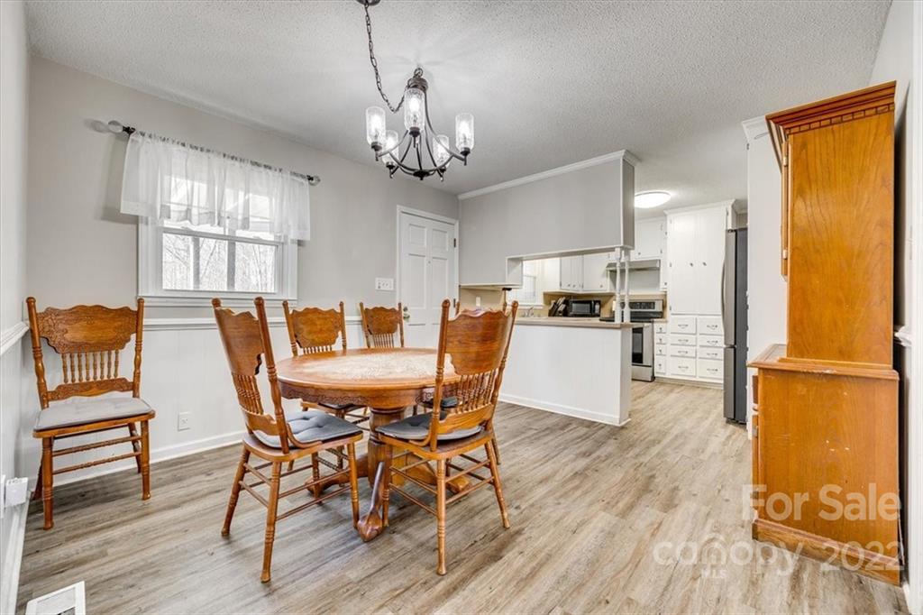 231 Essie Circle Fort Mill, SC 29708 - Photo 8 of 28 a view of a dining room with furniture and wooden floor