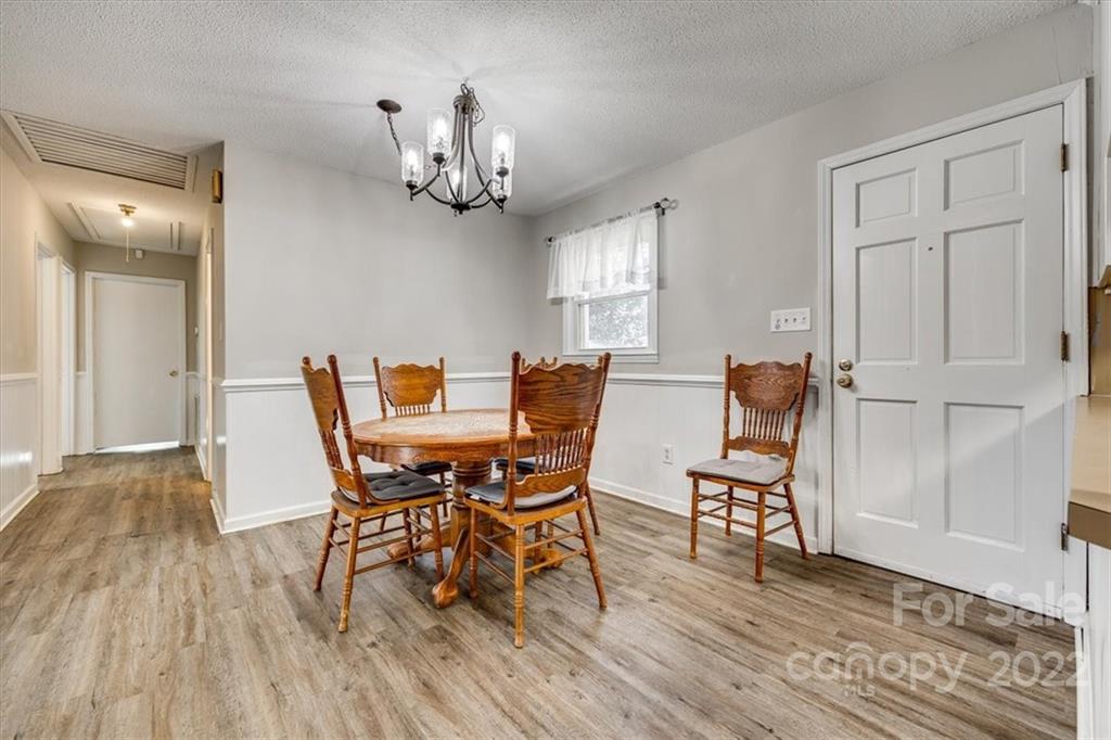 231 Essie Circle Fort Mill, SC 29708 - Photo 9 of 28 a view of a dining room with furniture and wooden floor