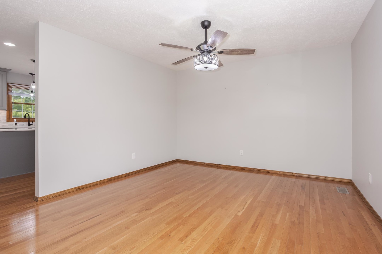 814 Landau Lane Normal, IL 61761 - Photo 31 of 58 a view of a room with wooden floor and a ceiling fan