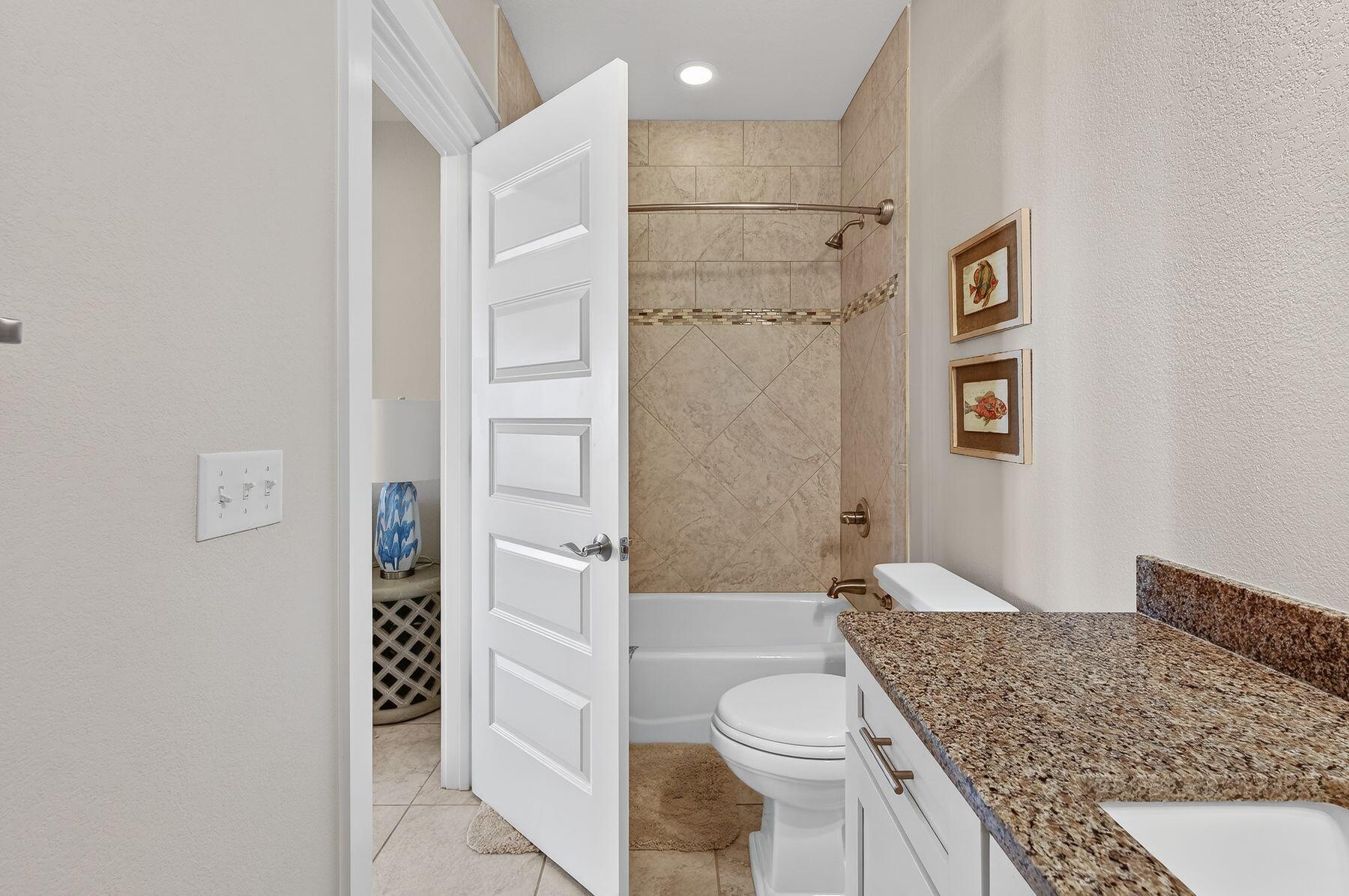 4480 Ocean View Drive Destin, FL 32541 - Photo 14 of 34 a bathroom with a granite countertop toilet sink and shower