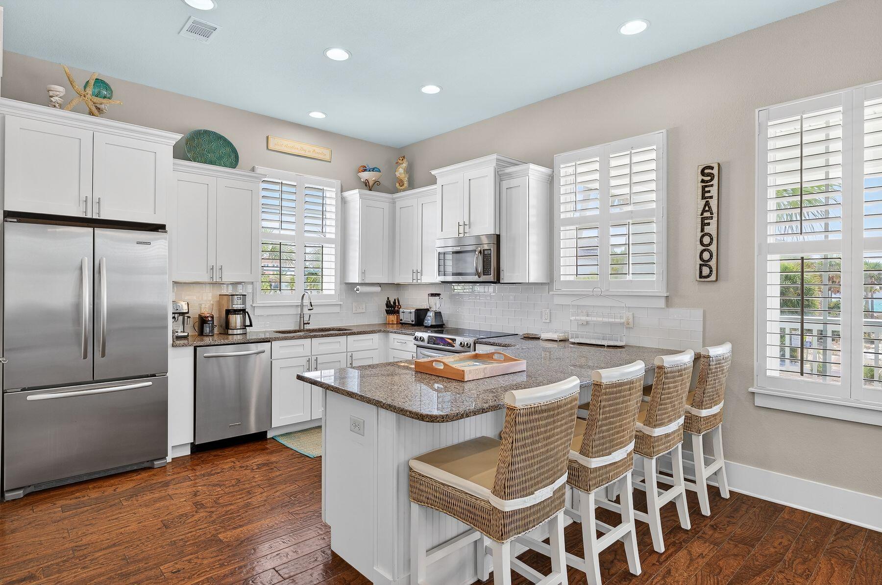 4480 Ocean View Drive Destin, FL 32541 - Photo 6 of 34 a kitchen with granite countertop stainless steel appliances a sink a counter space and a window