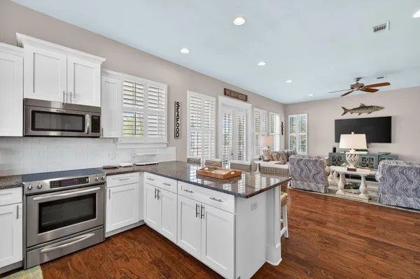 a open kitchen with sink stove and microwave