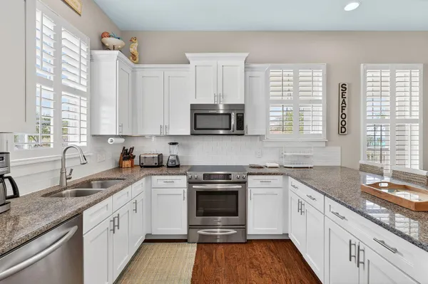 a kitchen with stainless steel appliances granite countertop a stove and a sink