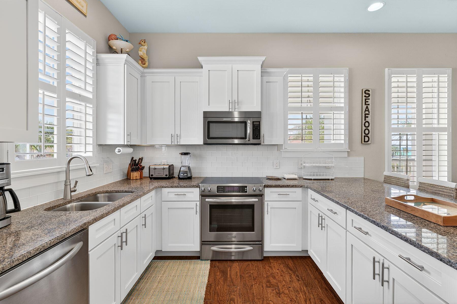 4480 Ocean View Drive Destin, FL 32541 - Photo 8 of 34 a kitchen with stainless steel appliances granite countertop a stove and a sink