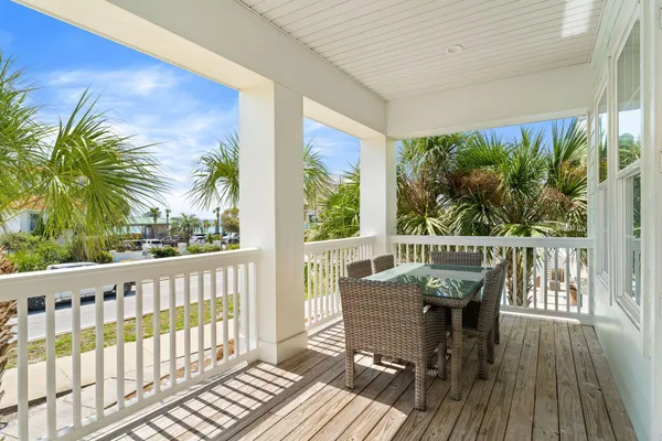 a view of a balcony with furniture and wooden floor