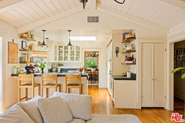 a living room with furniture a fireplace and a floor to ceiling window