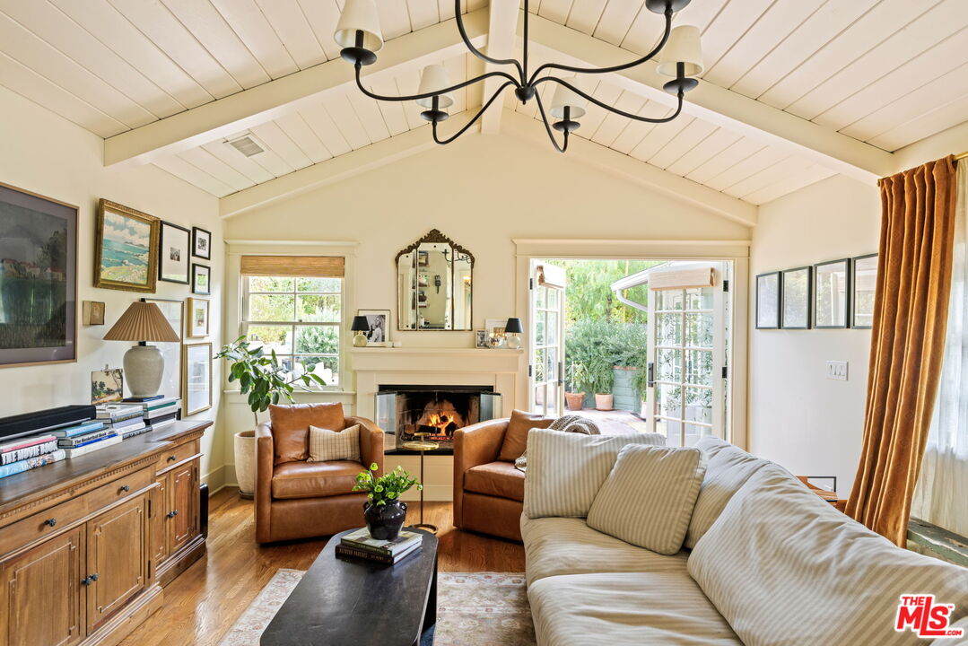 5152 Vincent Avenue Los Angeles, CA 90041 - Photo 19 of 36 a living room with furniture a fireplace and a floor to ceiling window
