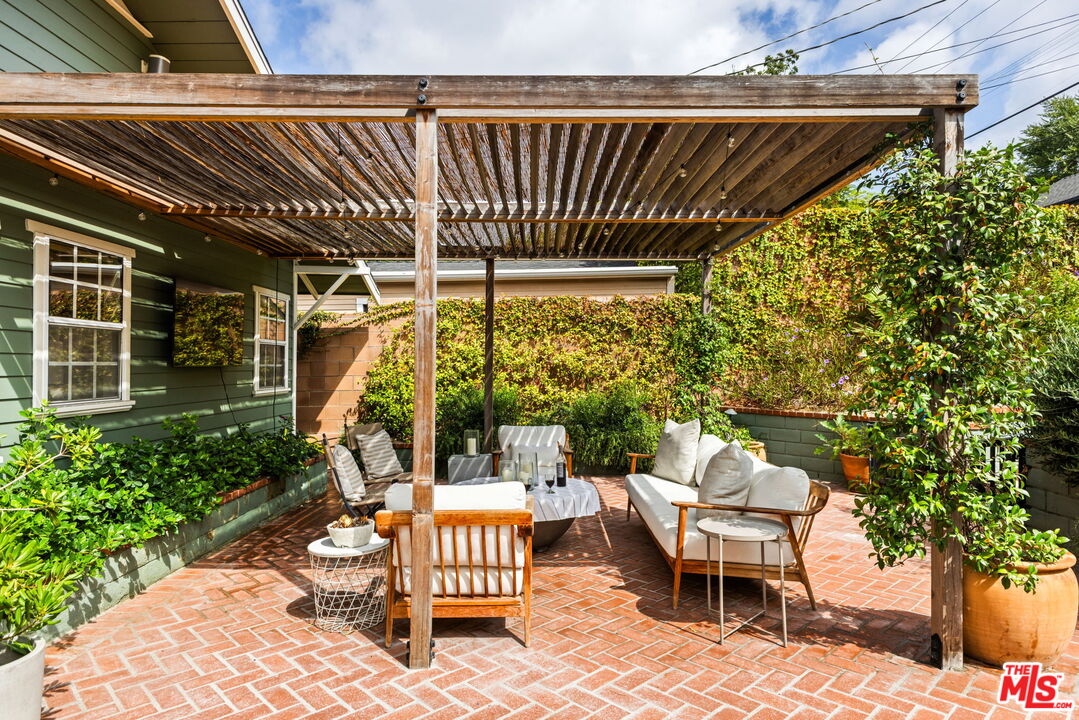 5152 Vincent Avenue Los Angeles, CA 90041 - Photo 22 of 36 a patio with glass top table and chairs