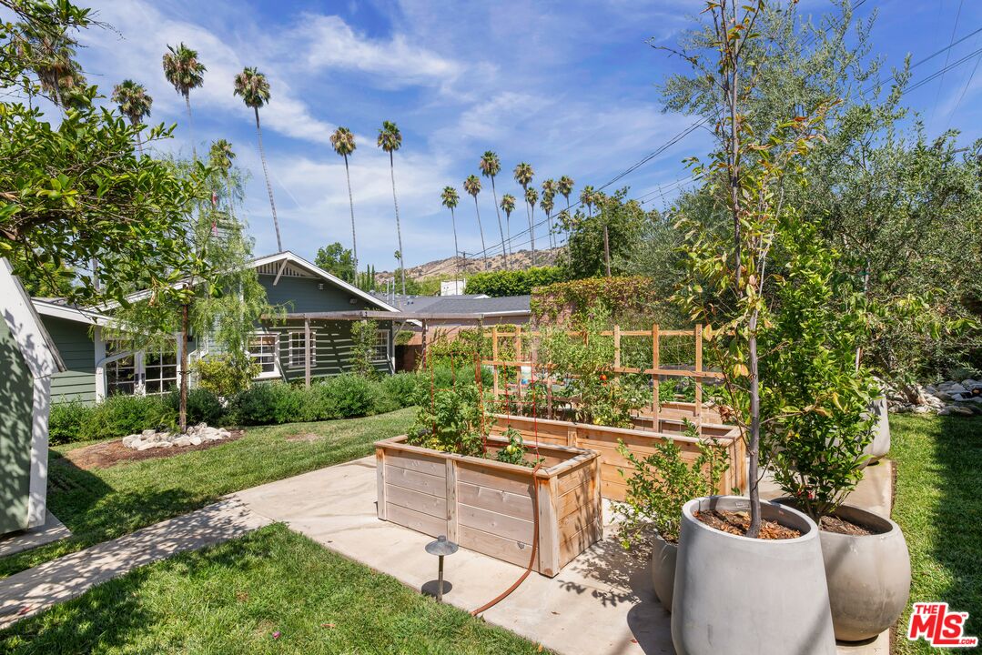 5152 Vincent Avenue Los Angeles, CA 90041 - Photo 25 of 36 a view of a patio with table and chairs potted plants and large tree