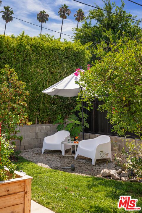 5152 Vincent Avenue Los Angeles, CA 90041 - Photo 26 of 36 a view of a patio with table and chairs and potted plants